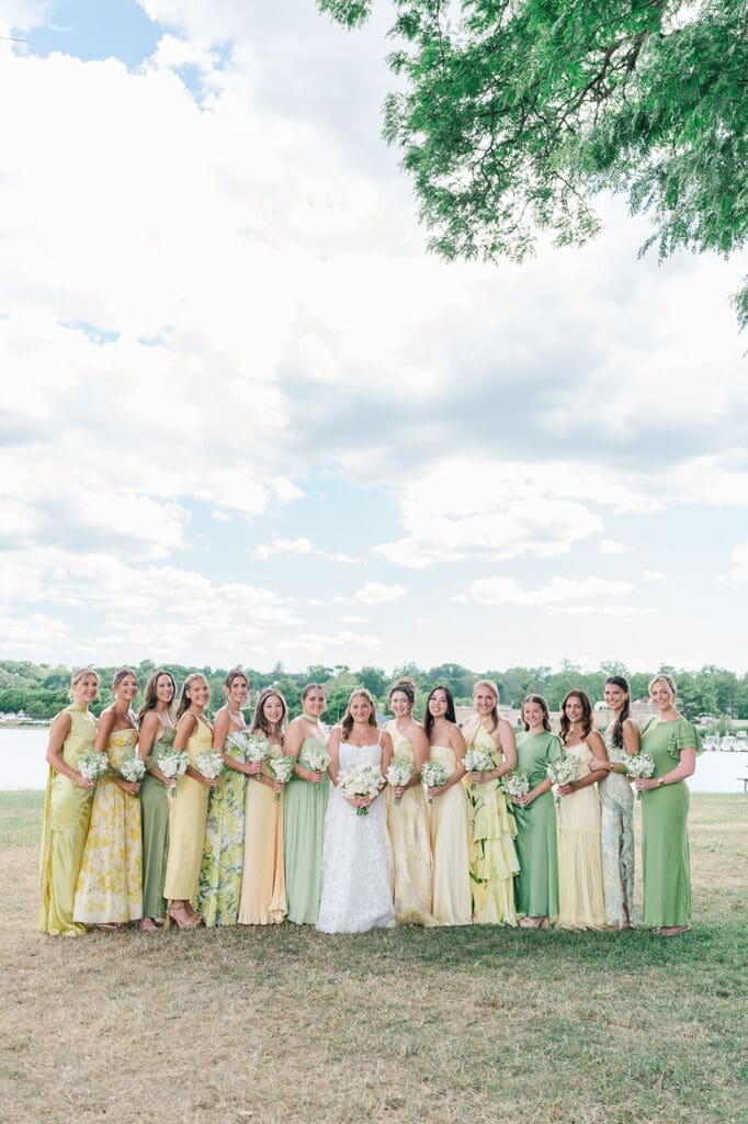 Katie and her 14 bridesmaids smile together