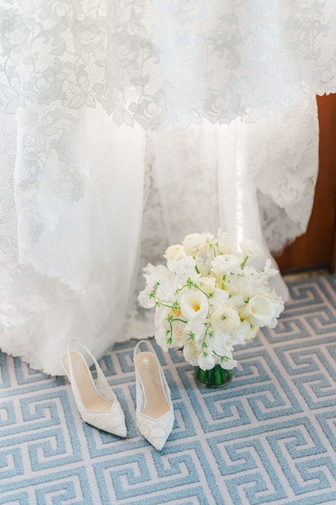 Katie's dress hangs with her bouquet and shoes nearby