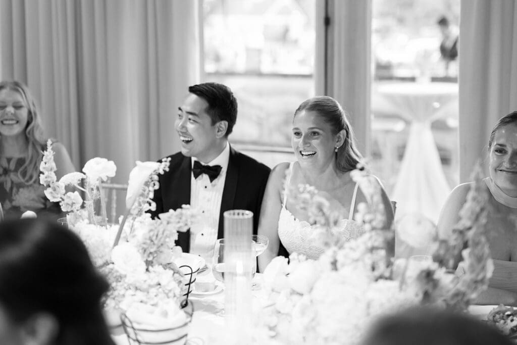 Katie and Sang laugh with their guests. 