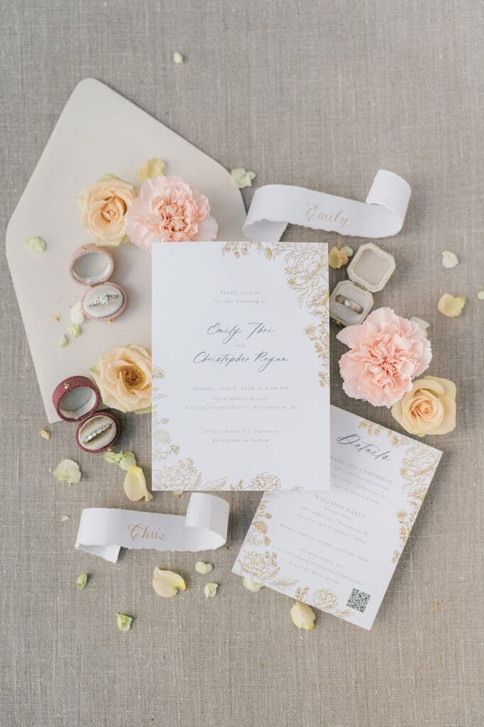 A wedding flat lay for Emily and Chris with their wedding invitations