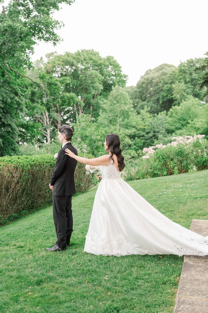 Emily taps Chris on the shoulder for their first look reveal. 