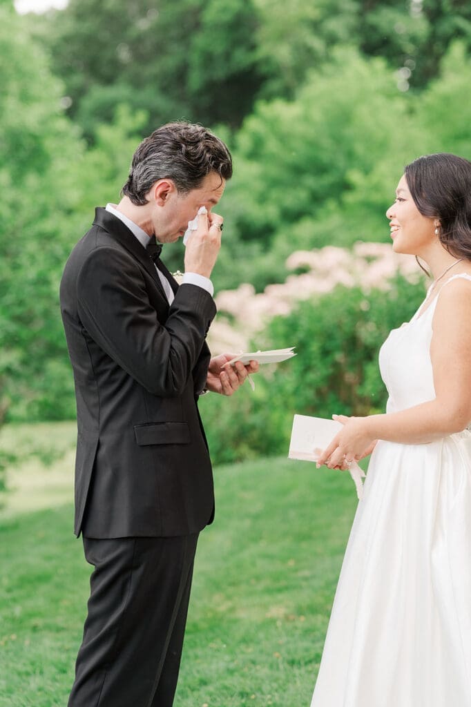 Chris wipes tears away as he reads his vows to Emily. 