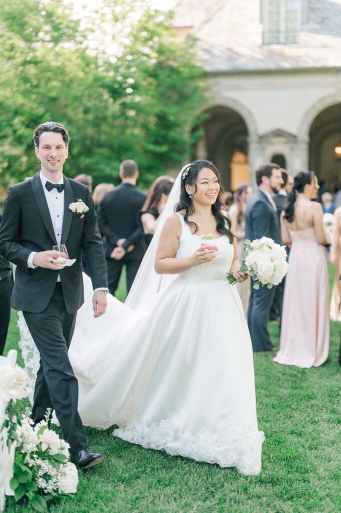 Emily and Chris walk during cocktail hour at Glen Manor. 