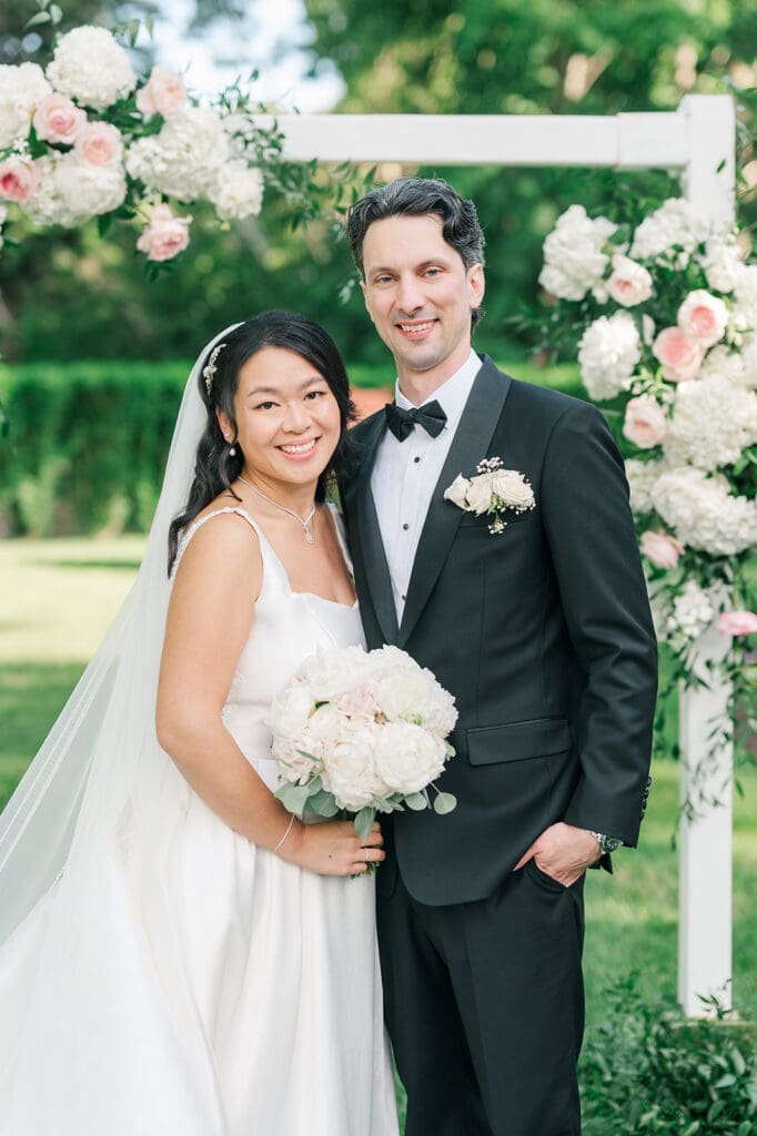 Emily and Chris smile together for a classic portrait. 