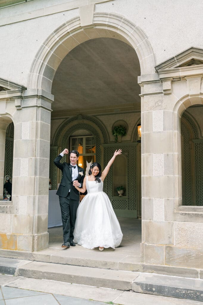 Emily and Chris enter their wedding reception cheering