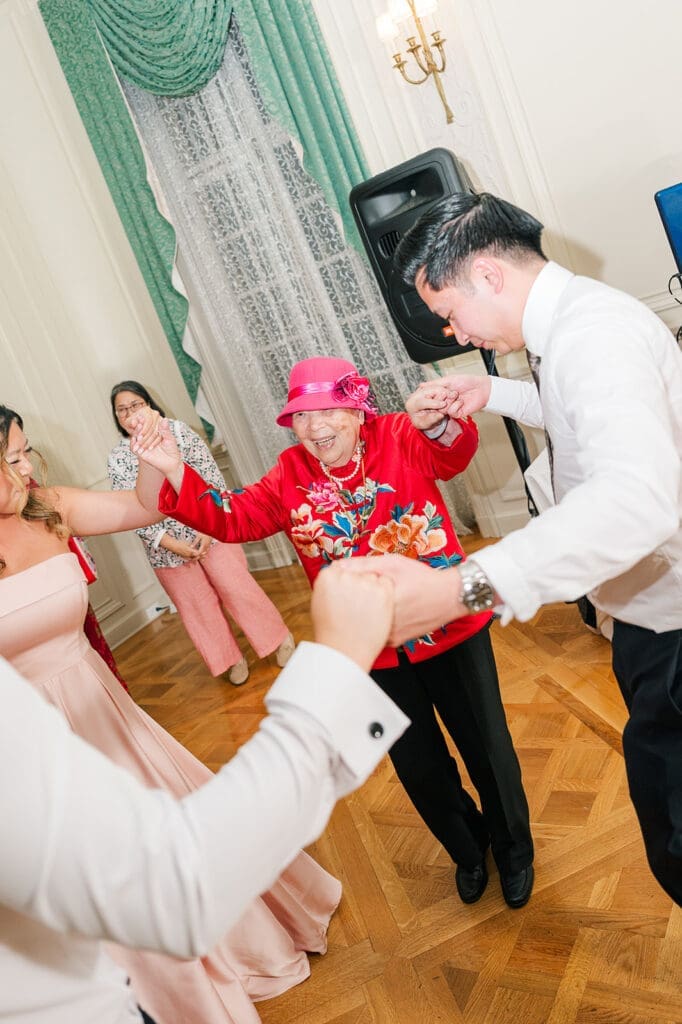 A grandma laughs as she dances on the dance floor