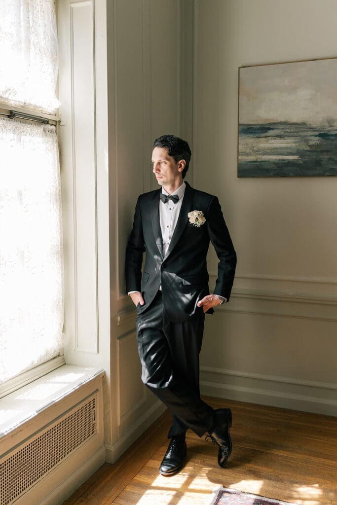 Chris looks out the window at Glen Manor House for his wedding