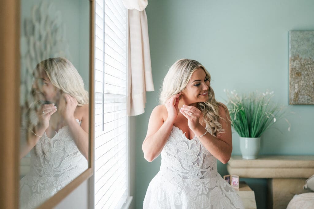 Jacquie puts in her earrings before her Anthony's Ocean View Wedding. 