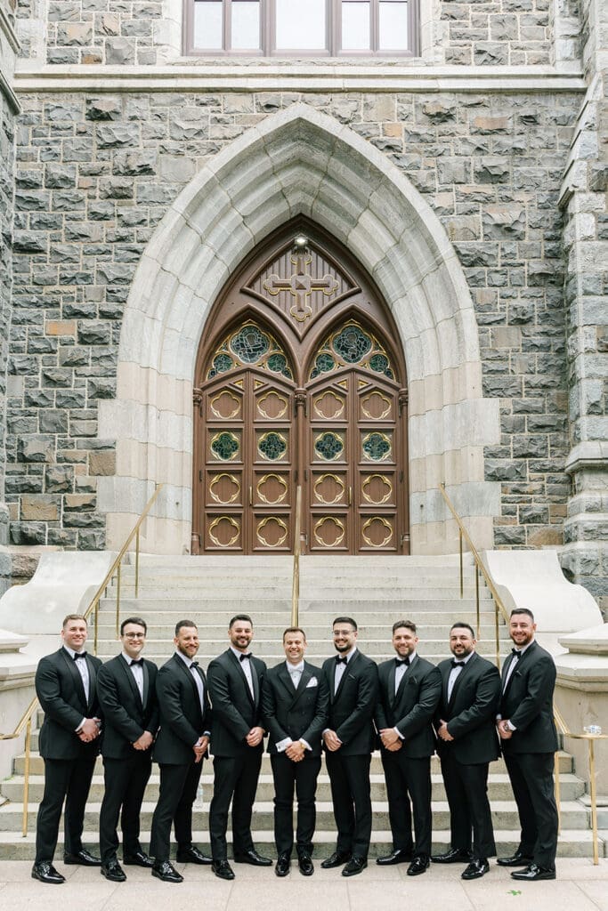 Thomas and his groomsmen stand outside of St. Mary's Church in New Haven before his Anthony's Ocean View wedding. 