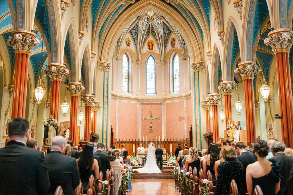 A wide angle of the couple standing on the Altar in St. Mary's Church. 
