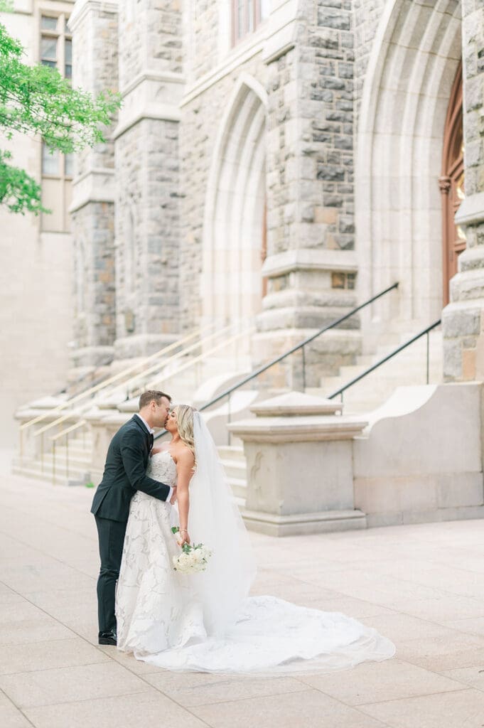 Jacquie and Thomas kiss outside of St. Mary's Church. 