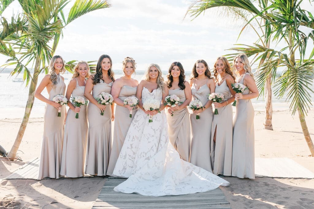 The bridesmaids stand on the beach at the Anthony's Ocean View wedding. 