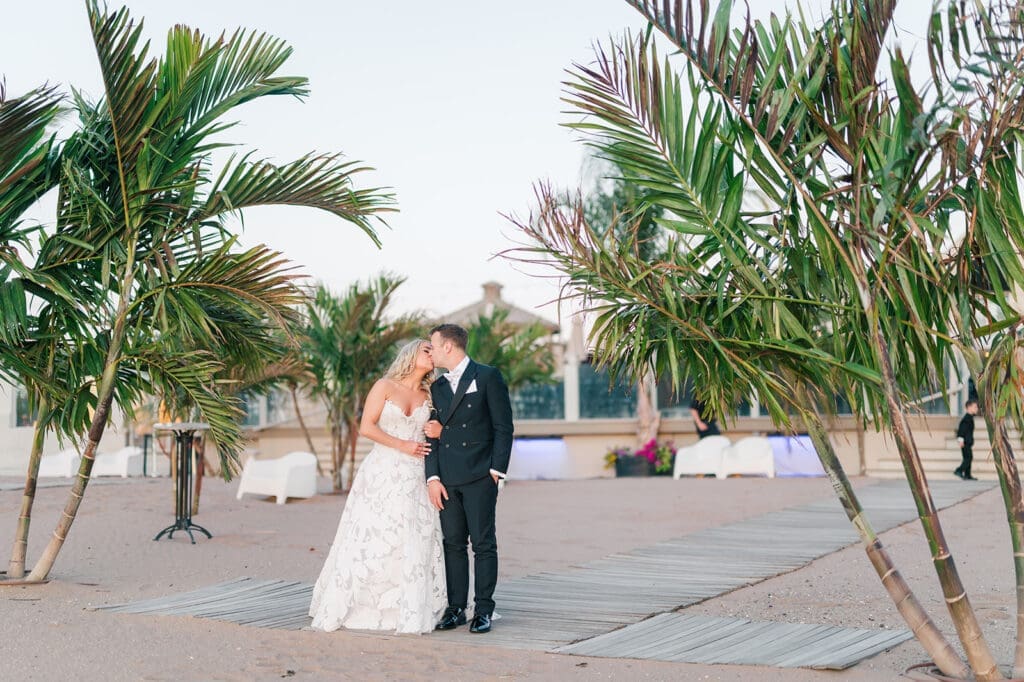 Jacquie an Thomas nuzzle noses on the sand at  their Anthony's Ocean View wedding. 