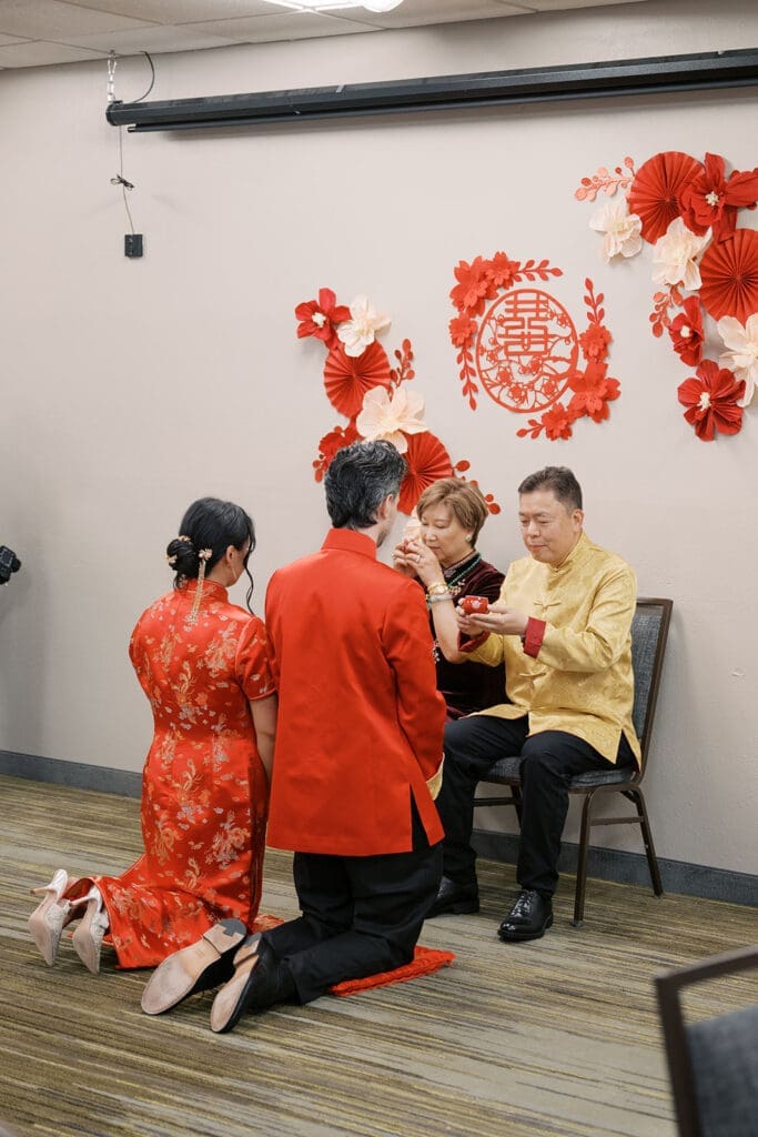 The brides parents drink tea at the Chinese Tea Ceremony