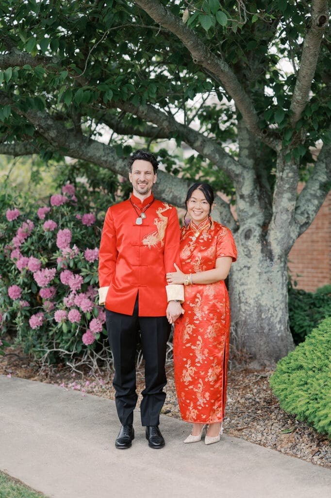 The bride and groom pose smiling after the chinese tea ceremony