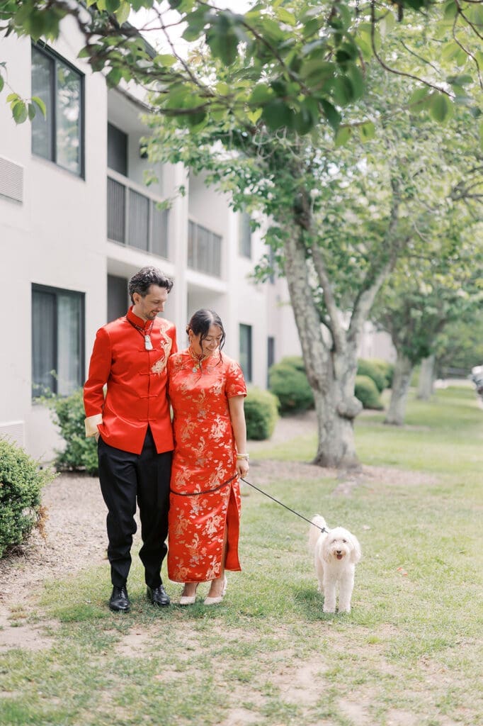 Emily and Chris walk their dog, Butter, outside of the hotel