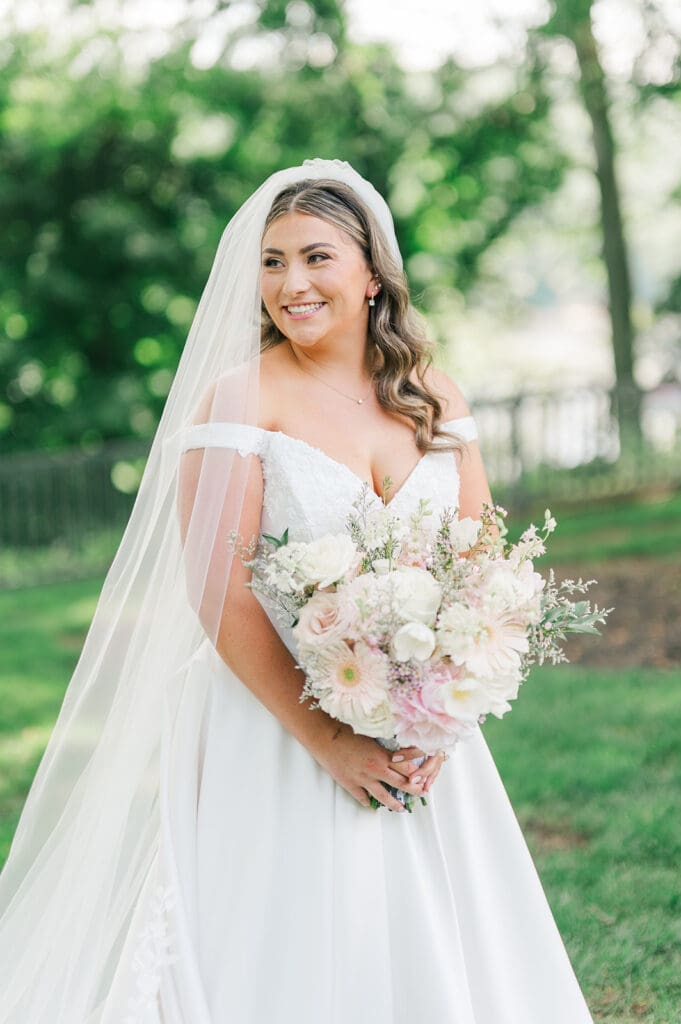 A bridal portrait of Sophie holding her bouquet