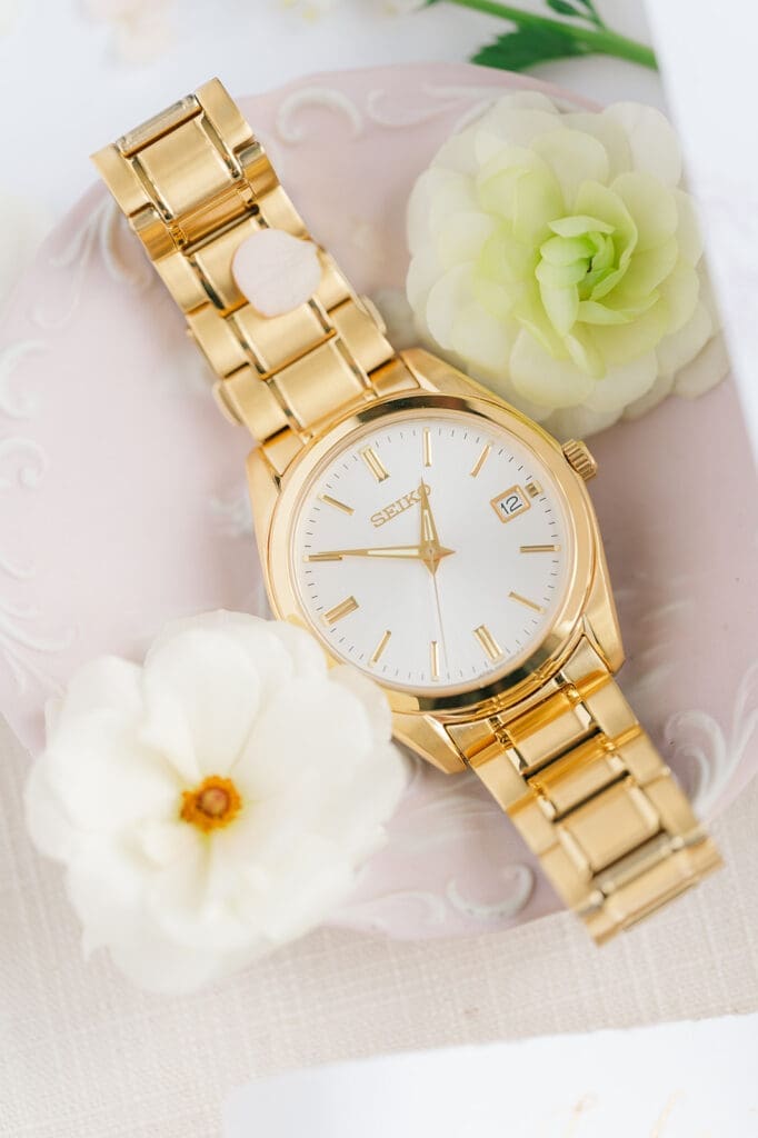 A gold seiko watch in a flat lay