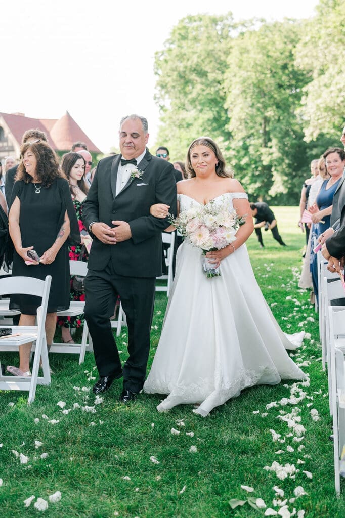 Sophie walks down the aisle at her Saint Clements Castle Wedding outside of the Waterford Room. 