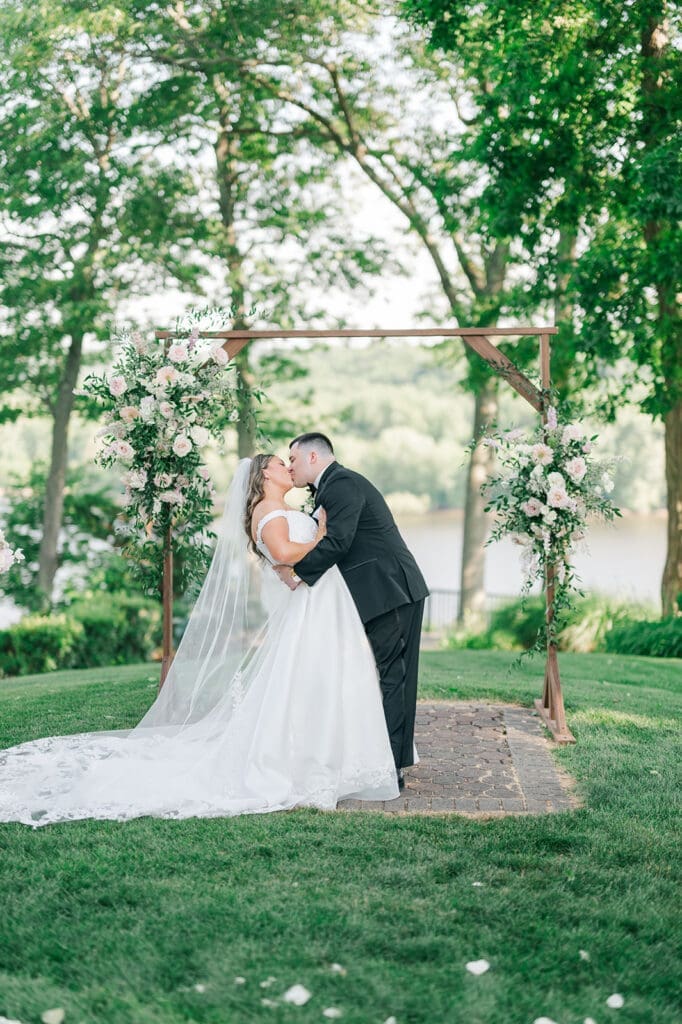 Sophie and John share their first kiss at their outdoor ceremony 
