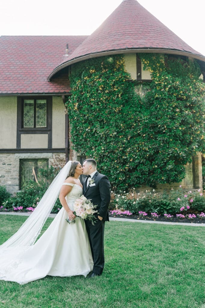 Sophie and John kiss next to Saint Clements Castle