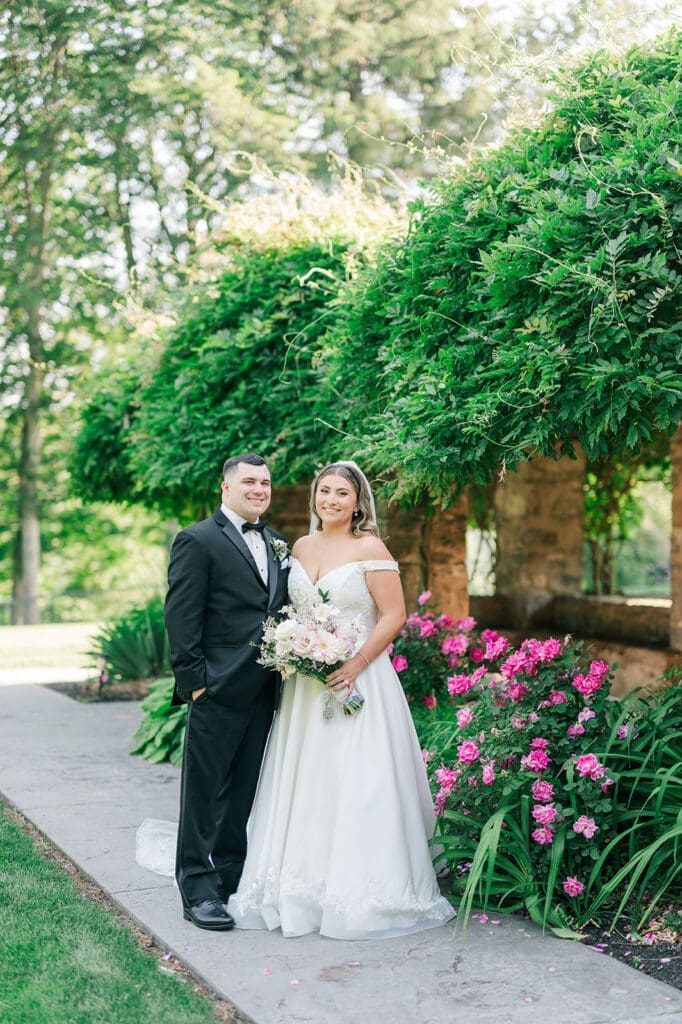 Sophie and John smile for a classic wedding portrait