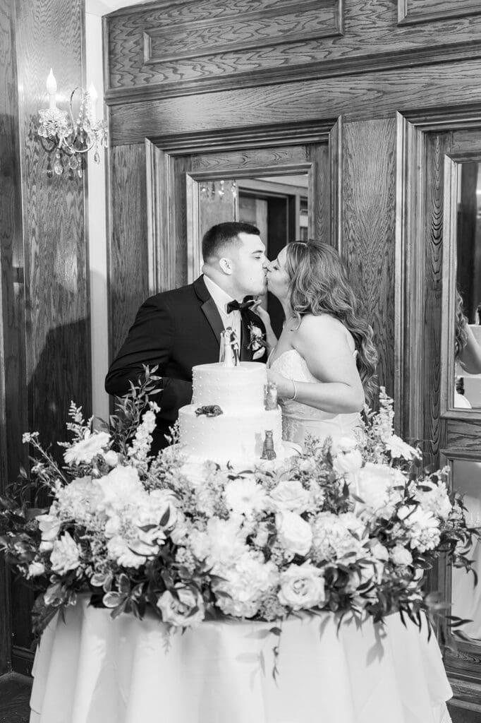 Sophie and John kiss after they cut their cake