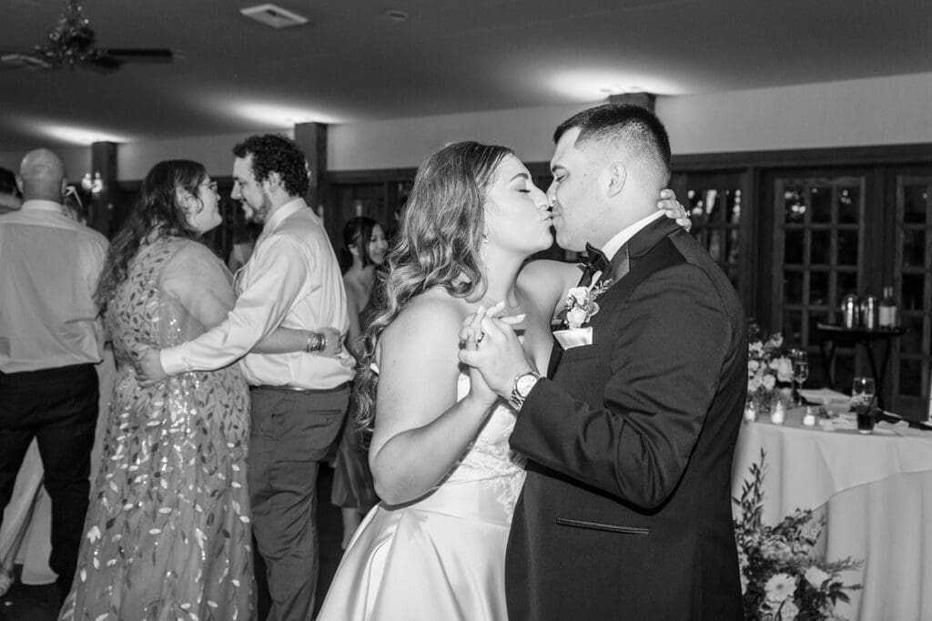 Sophie and John dance and kiss together. 