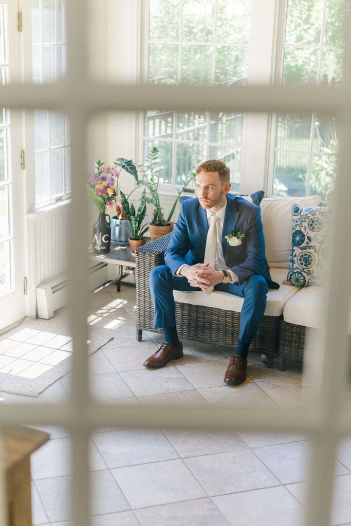 Conor peers out the window in his wedding outfit