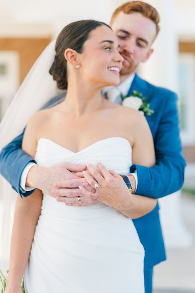 Conor hugs Amy from behind at their Wampanoag Country Club Wedding.