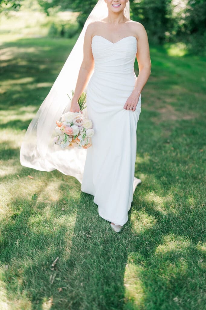 Amy smiles and walks in her wedding dress