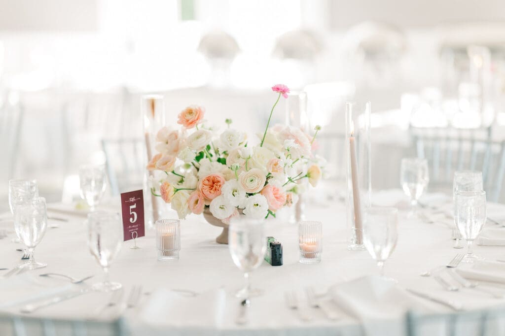 A beautiful pink, white, and orange centerpiece by Willow and Grey Floral at a Wampanoag Country Club Wedding