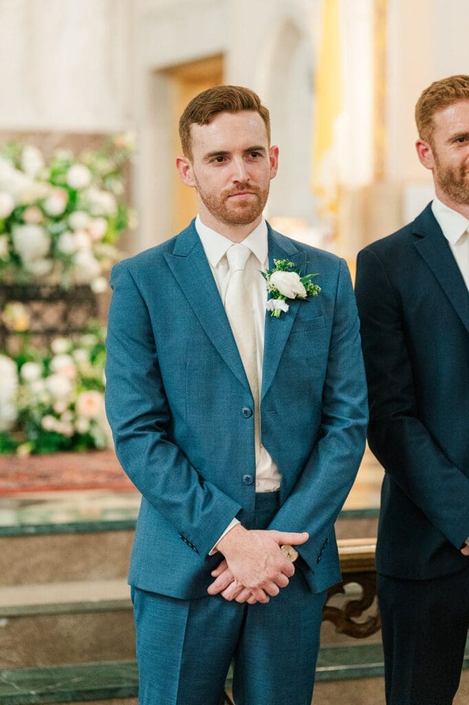 Conor smiles as he waits for Amy to walk down the aisle