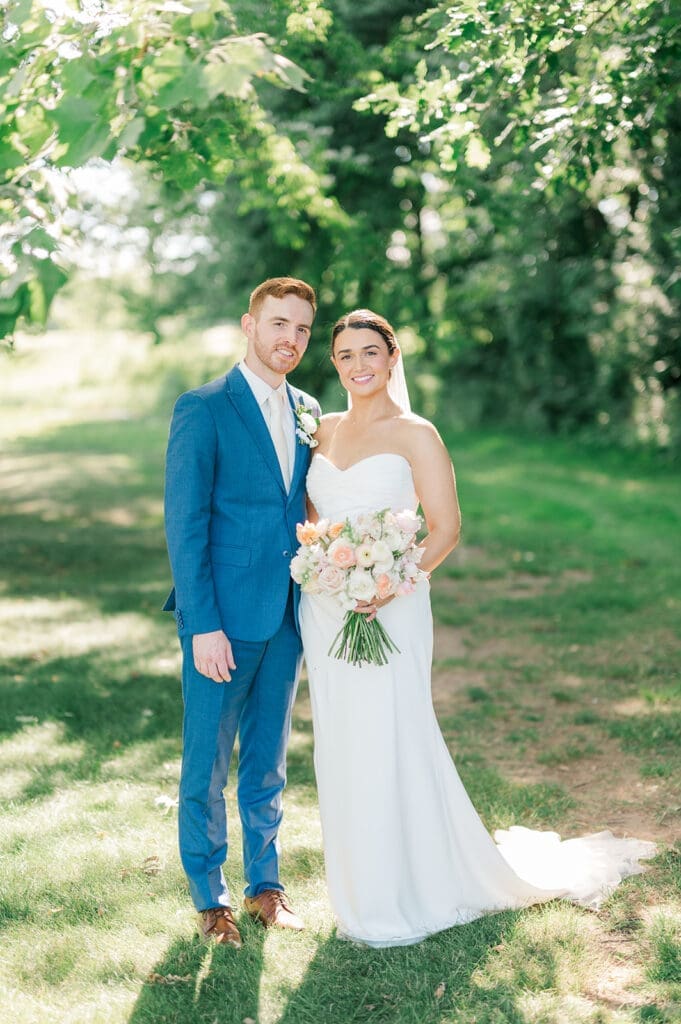 Amy and Conor smile together for a classic portrait at their Wampanoag Country Club Wedding