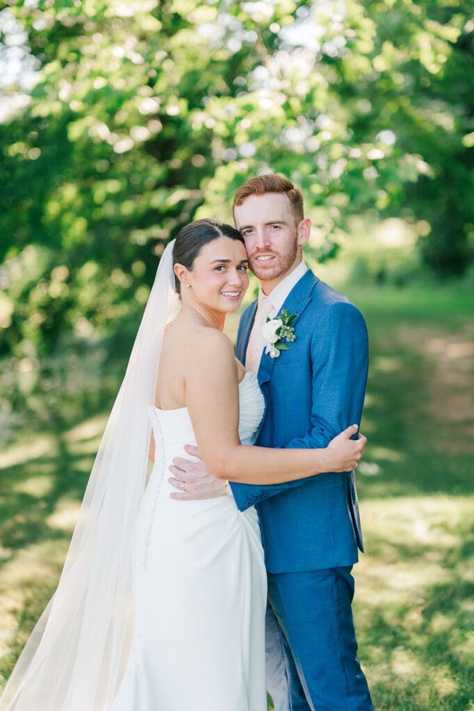 Amy and Conor hug and smile one another at their Wampanoag Country Club Wedding