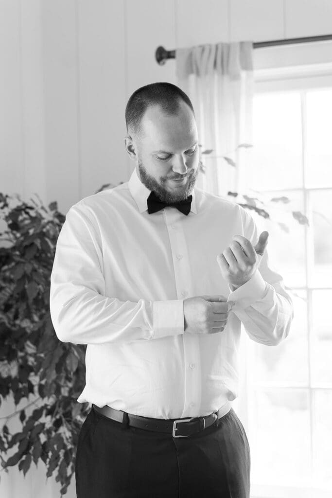 Kevin adjusts his cufflinks in the guest house at Smith Farm Gardens.