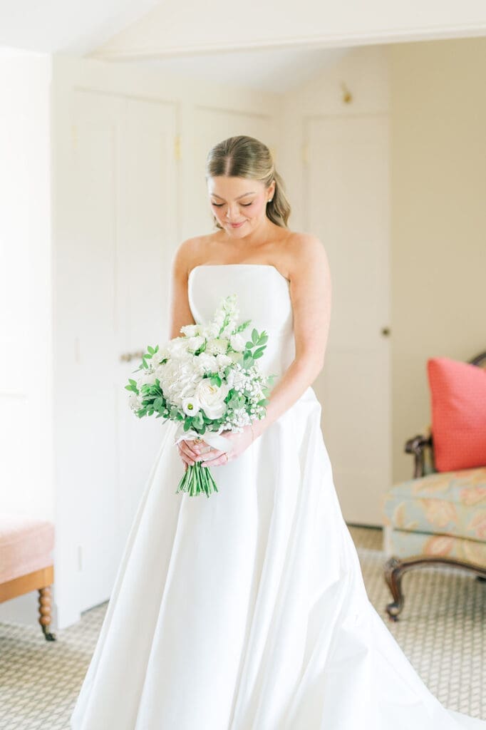 Georgia looks down at her wedding bouquet.
