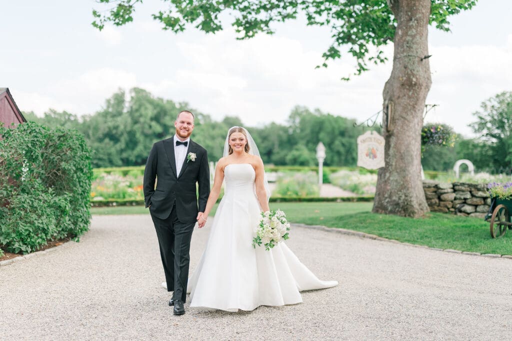 Georgia and Kevin walk holding hands on the driveway at Smith Farm Gardens.