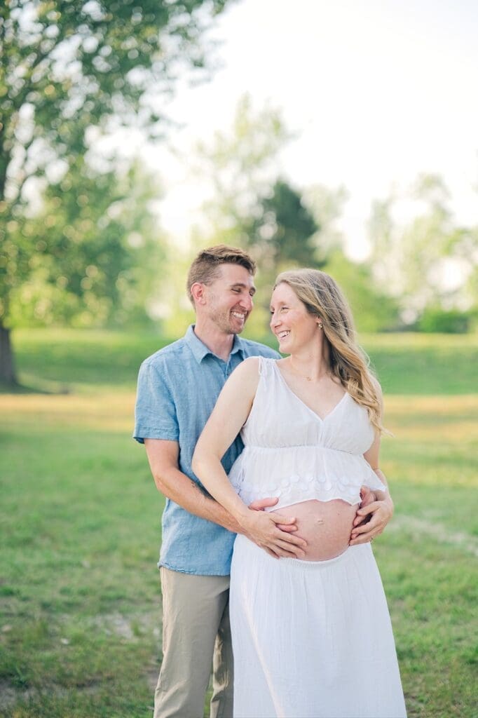 Lindsey and Rich smile with one another for their maternity photoshoot in CT