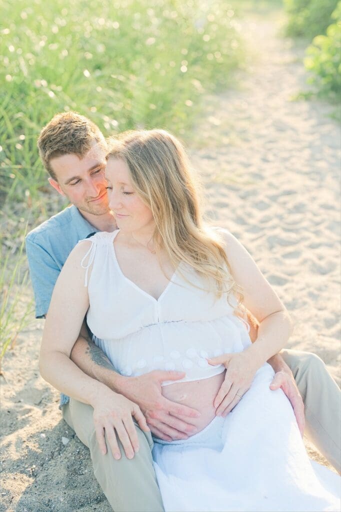 Lindsey sits with Rich and leans back and smiles.