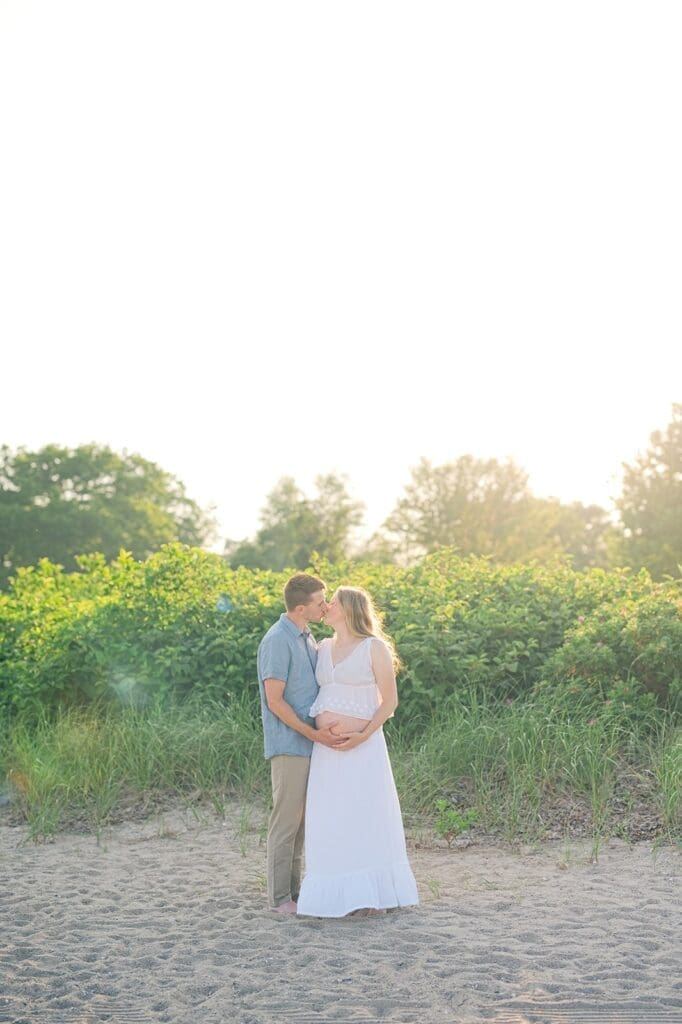 Rich and Lindsey kiss one another on the beach in Westport, CT.