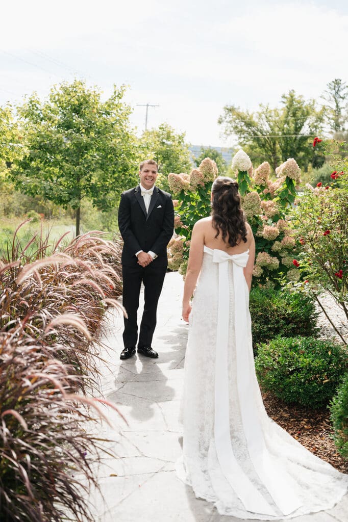A groom sees his bride for the first time at their Barnstead Inn wedding. 