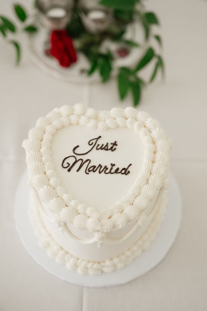 A heart-shaped cake that says "Just Married".