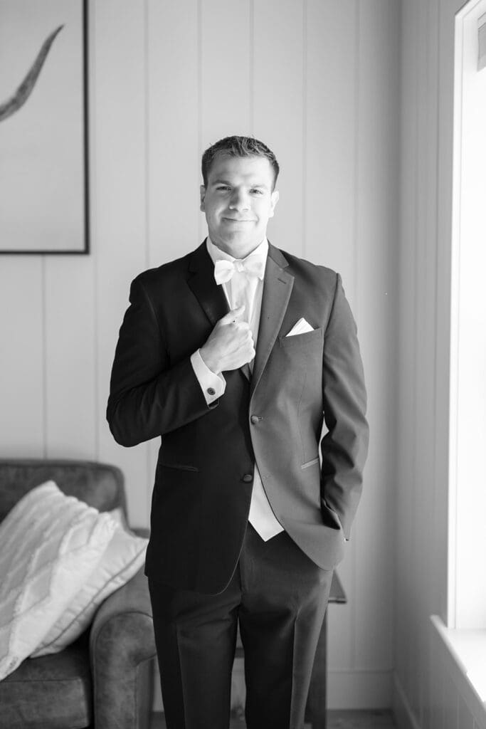 A groom softly smiles. 