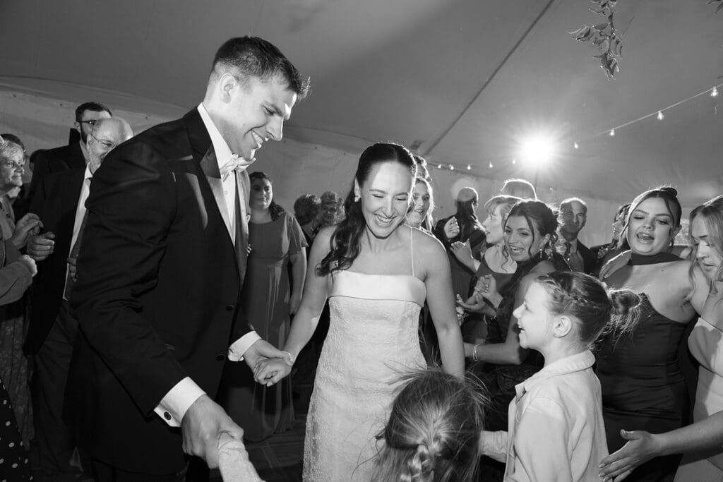 The bride and groom dance on the dance floor during their wedding reception. 