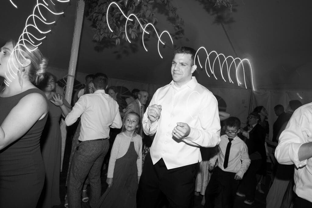 The groom dancing on the dance floor. 