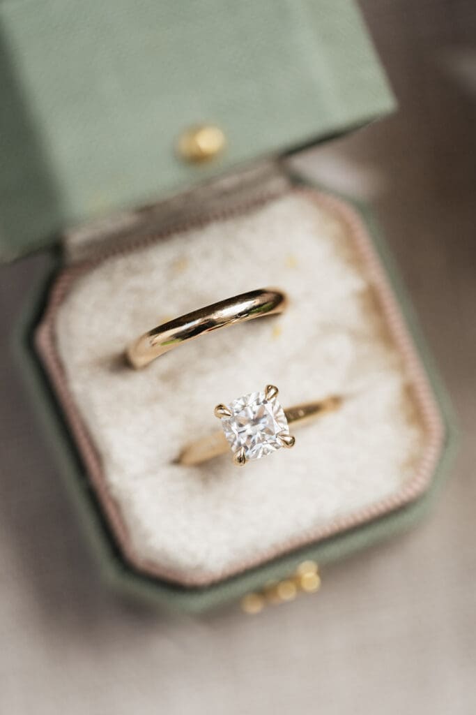 A macro photo of a bride's wedding ring and engagement ring. 
