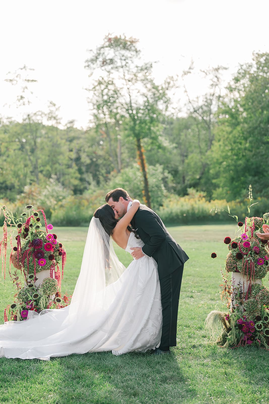 A bride and groom sharing their first kiss as husband and wife at their wedding ceremony at the Litchfield Inn.