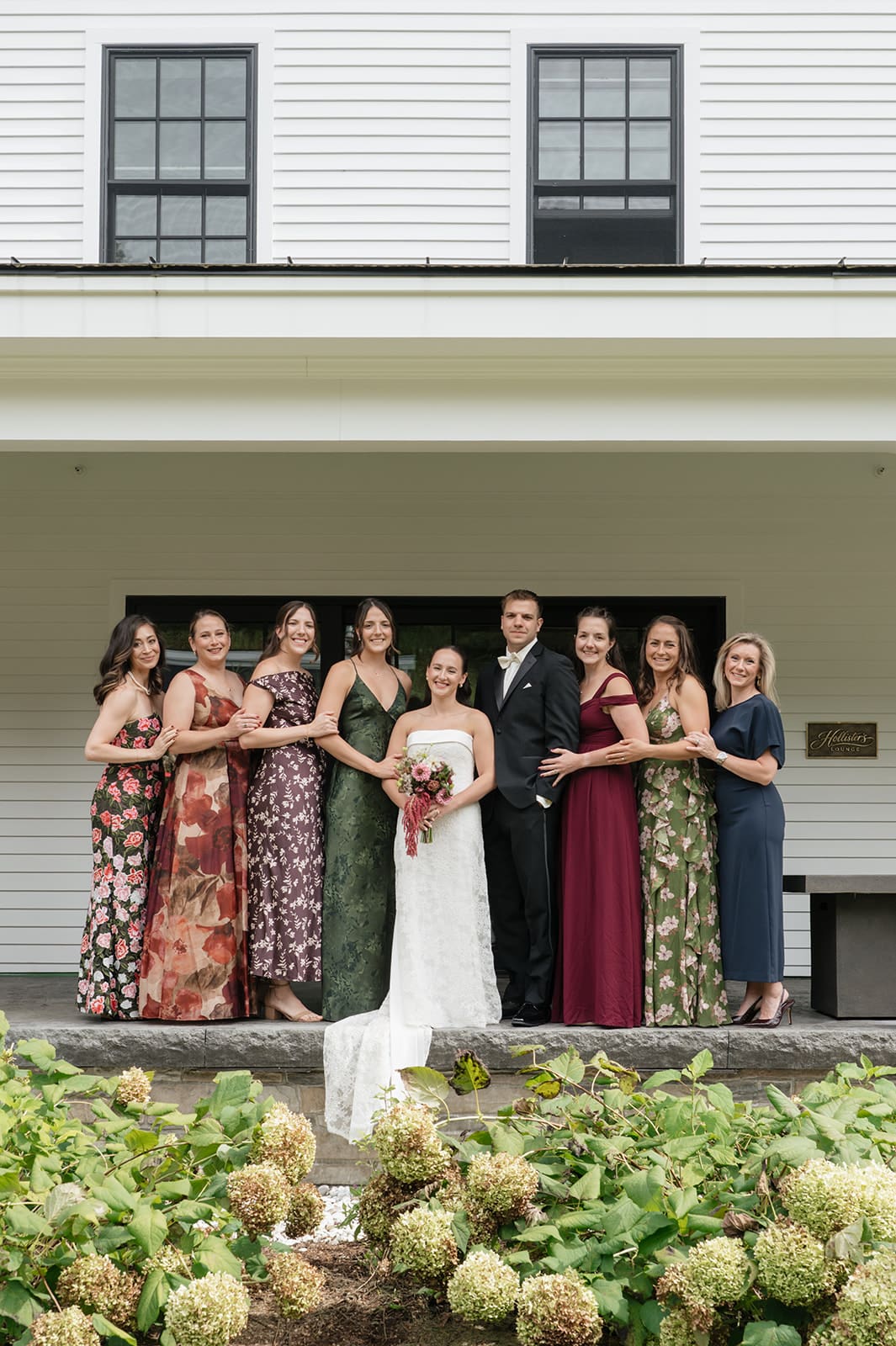 A family portrait with 9 individuals in it.